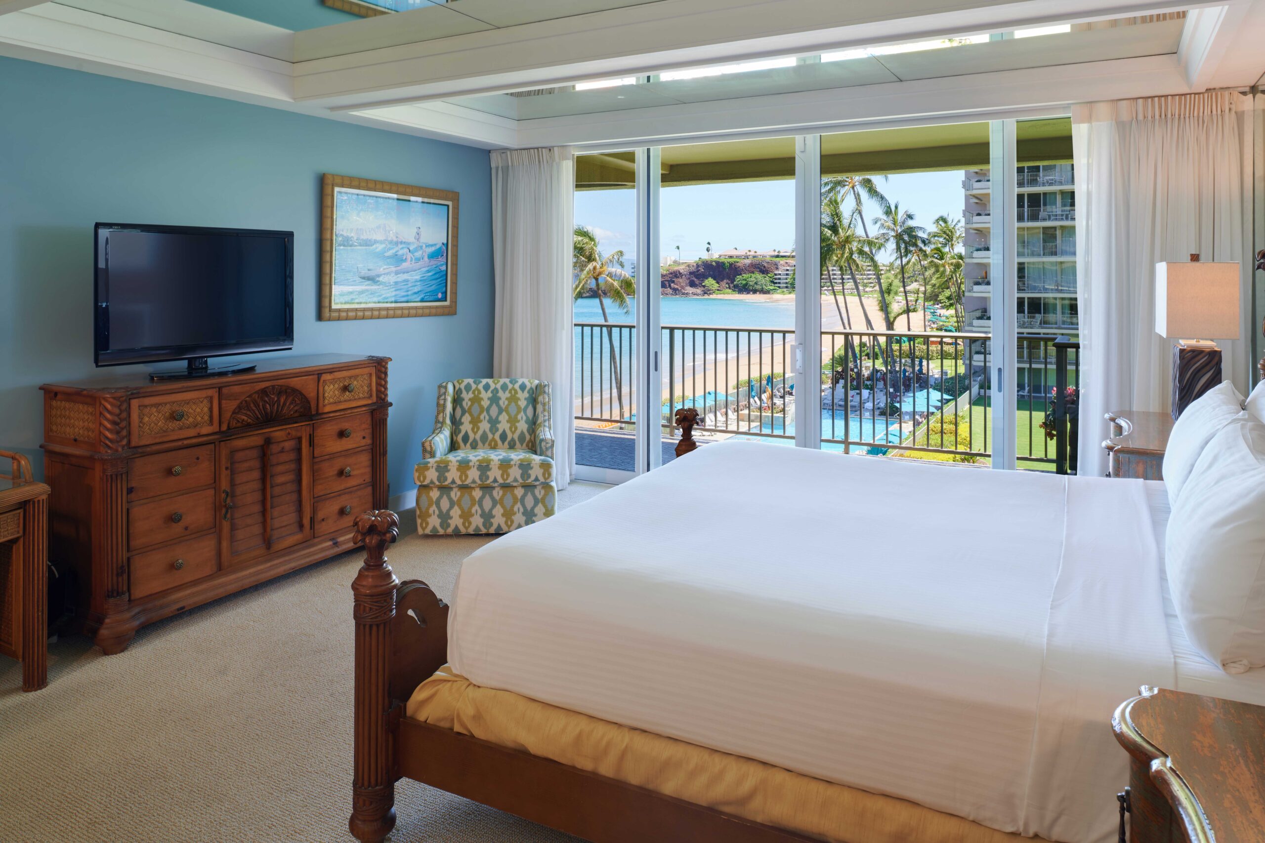 2-bedroom oceanfront premium master bedroom with king bed, TV, dresser, and open balcony