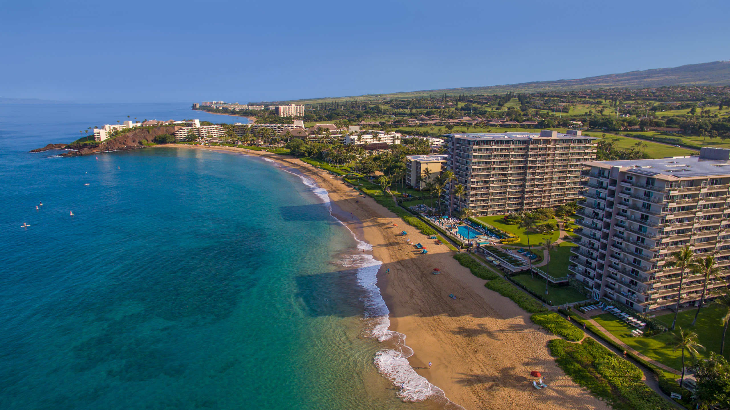 Aerial view of Kaanapali Beach, and the hotel towers and pool