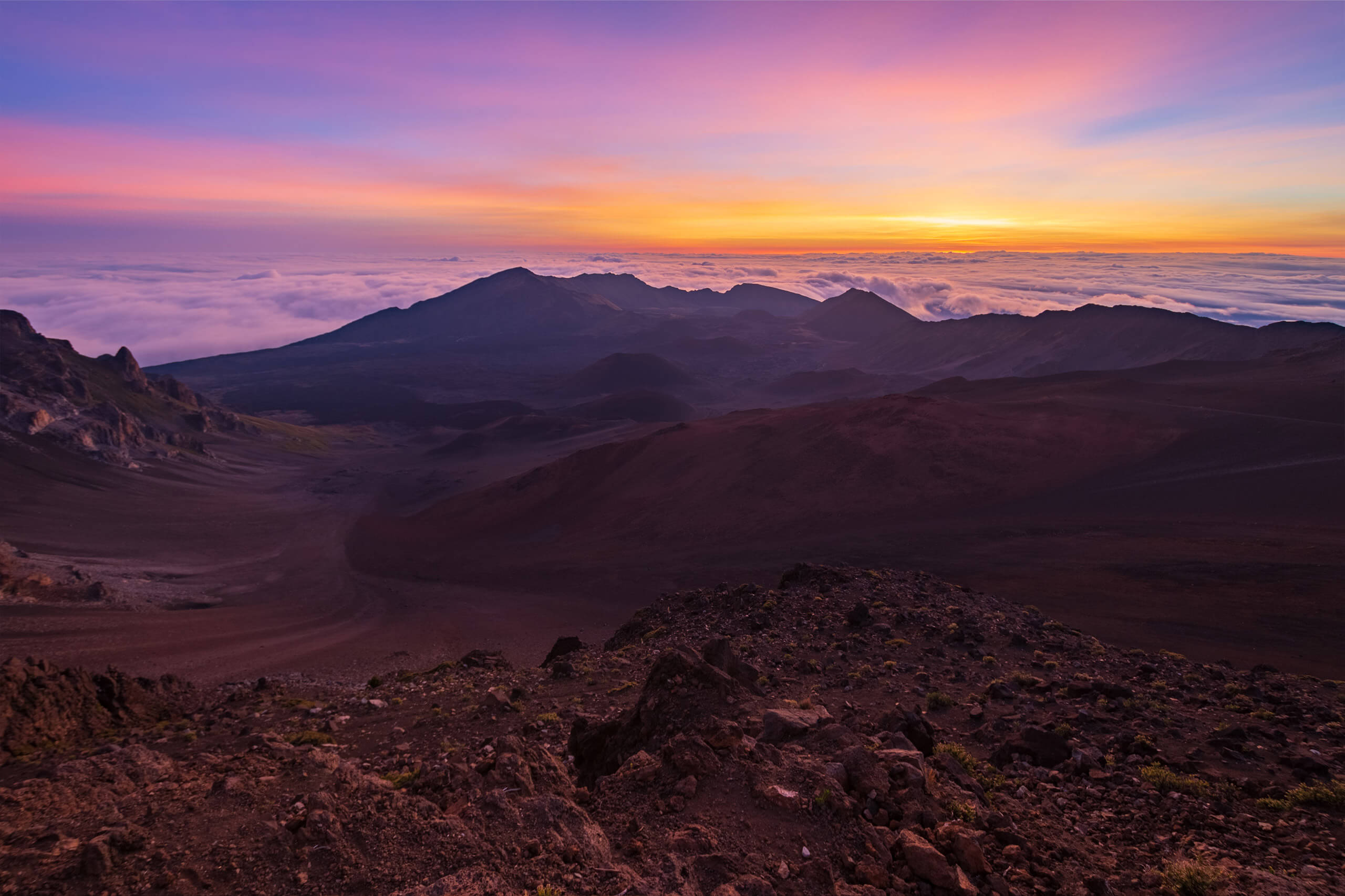 colorful sky with volcano ridge outline